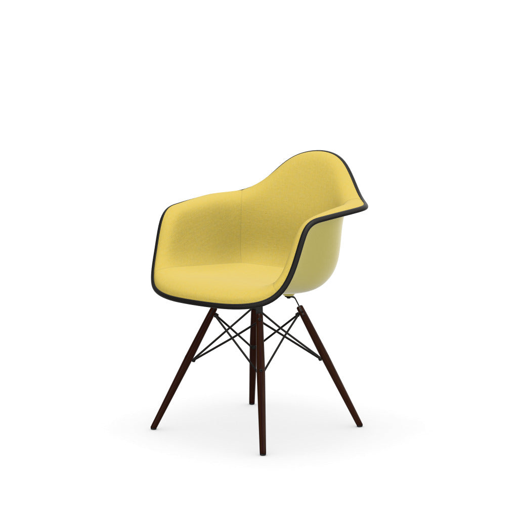 Eames Plastic Armchair DAW by Vitra with yellow upholstered seat and dark wood base.

