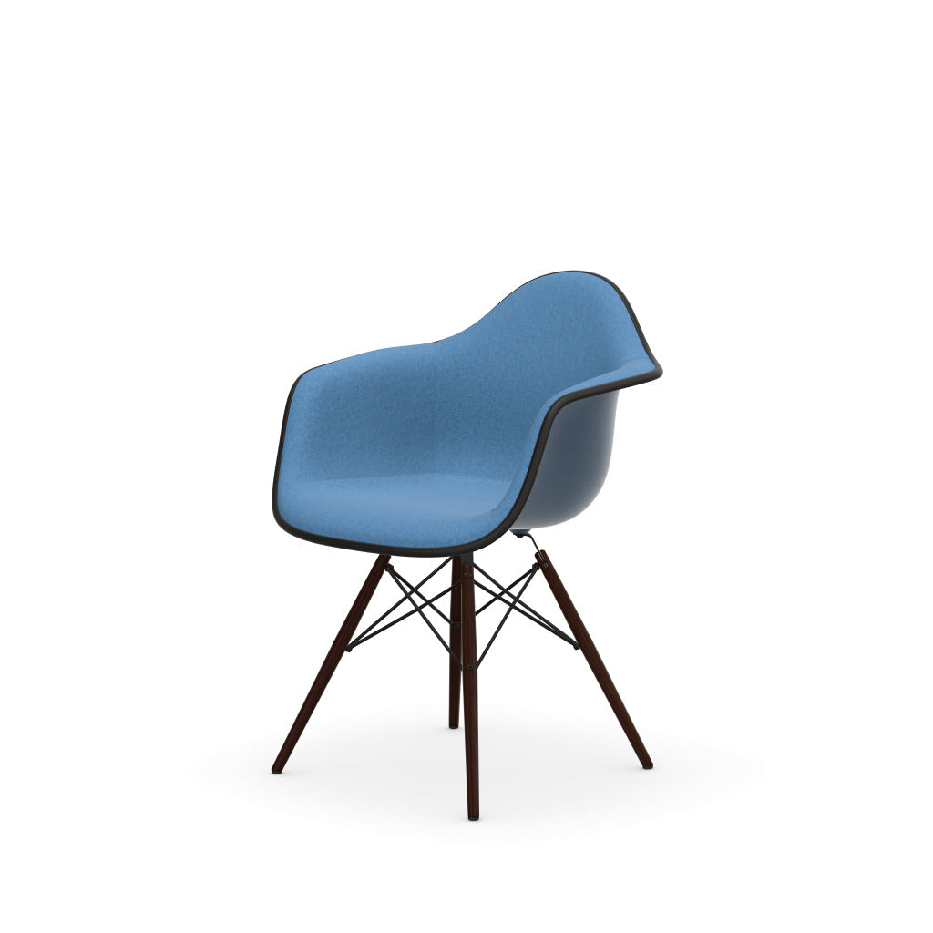 Eames Plastic Armchair DAW by Vitra with blue upholstered seat and dark wood base.
