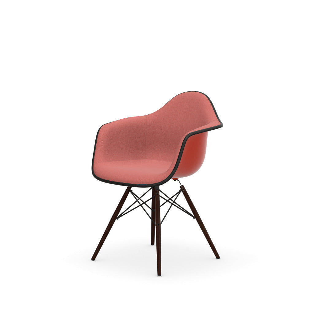 Eames Plastic Armchair DAW by Vitra with red upholstered seat and dark wood base.


